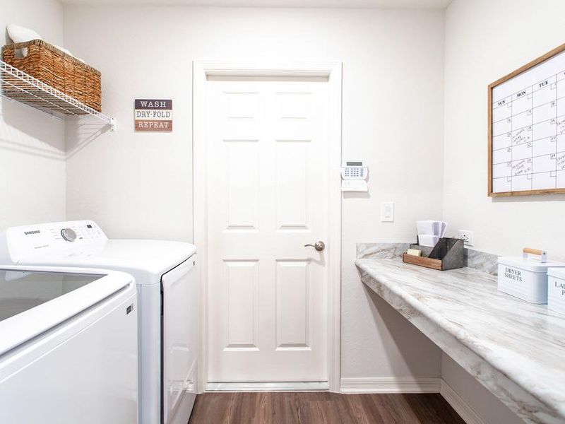 A drop zone at the garage entry helps keep clutter off your kitchen counters - Parker model home in Eagle Lake, FL