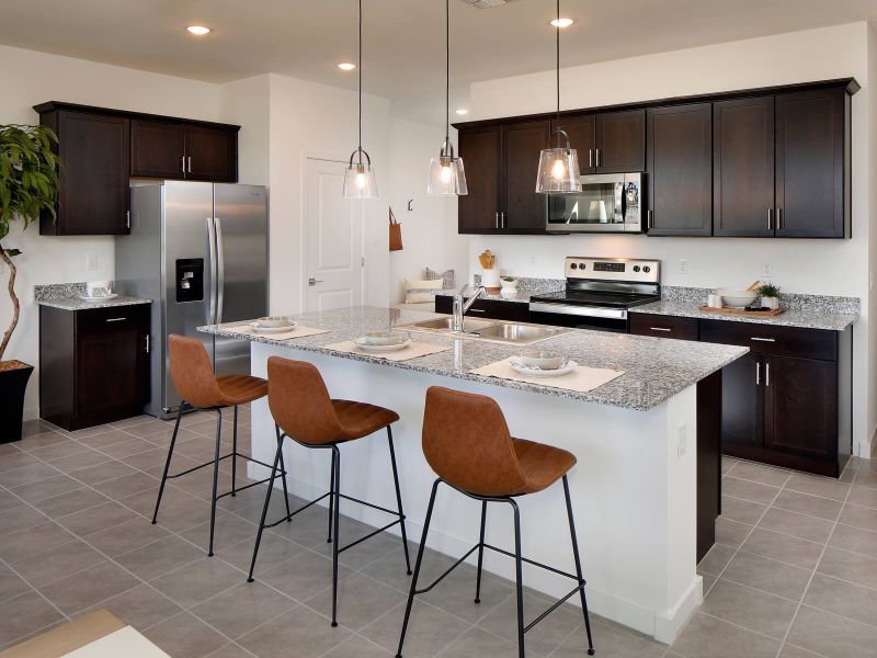 Gray speckled countertops and brown cabinets