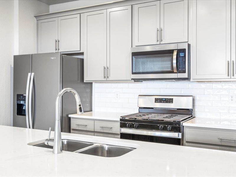 Kitchen in the Orchard floorplan at a Meritage Homes community in Aurora, CO.