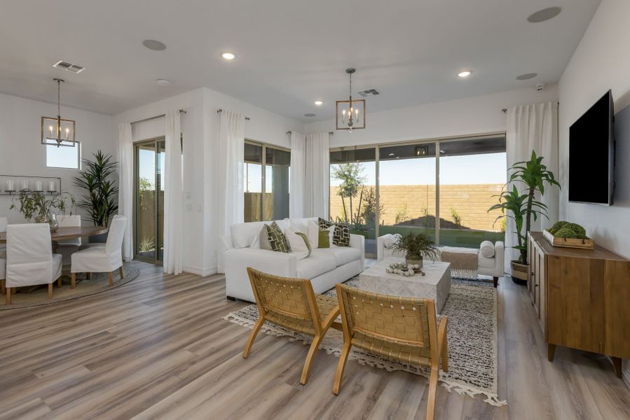 Jimson Great Room Open Floor Plan. Beautiful modern design with touches of white, green and brown. View to outdoors new home construction William Ryan Homes Phoenix
