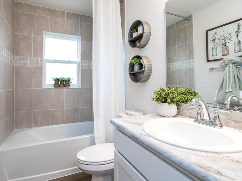 A hall bath serves the secondary bedrooms and guests - Parker model home in Eagle Lake, FL
