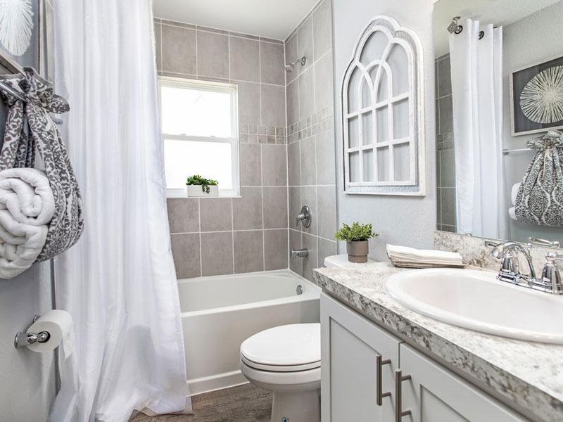 A hall bath serves the secondary bedrooms and guests - Raychel model home in Palmetto, FL