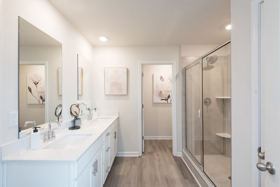 Enjoy your primary ensuite bath with a walk-in shower and dual vanity sinks.
