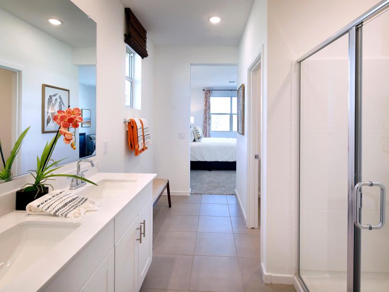 Walk-in shower, bath, and dual sinks in the primary bathroom