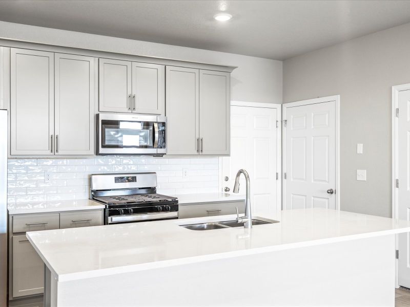 Kitchen in the Orchard floorplan at a Meritage Homes community in Aurora, CO.