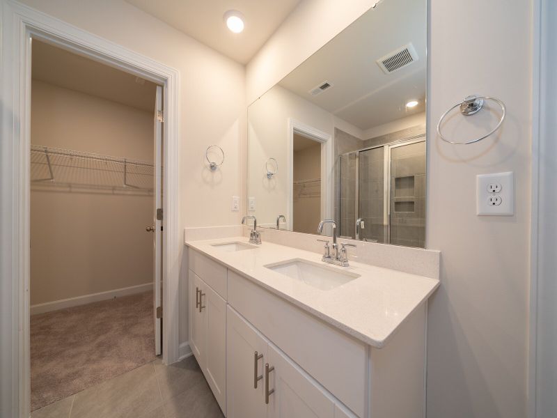 The primary bath offers dual sinks and a large walk-in closet.