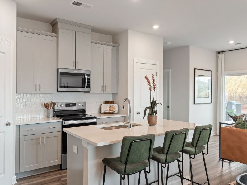 The well-appointed kitchen with a large island makes meal prep a breeze.