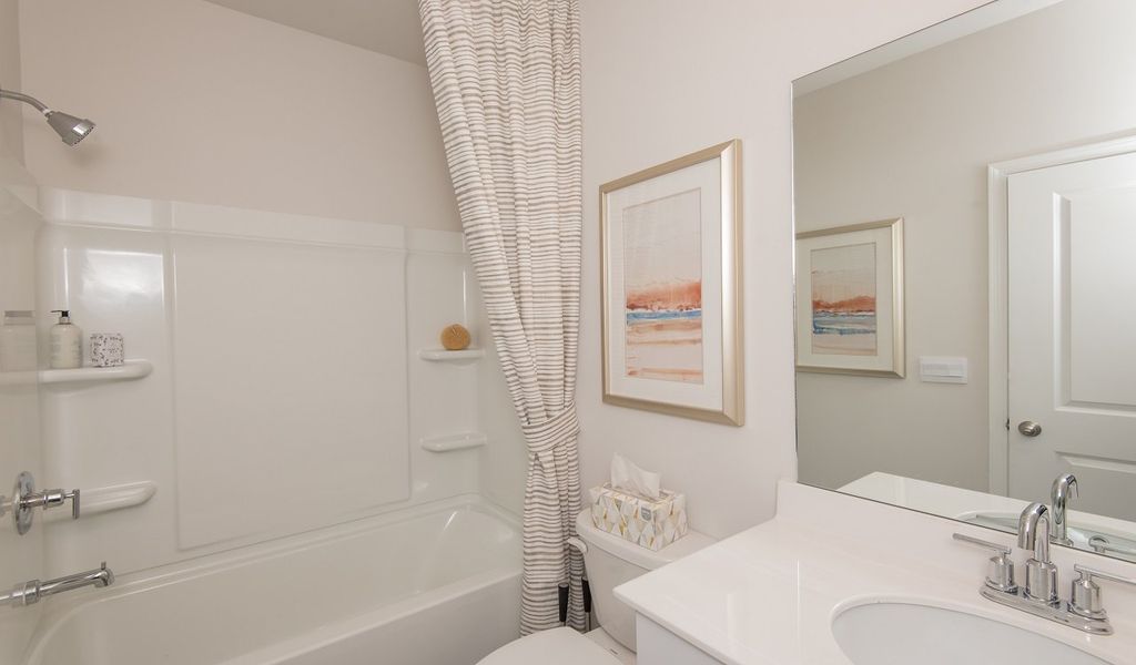 A full bedroom and bathroom on the main floor are perfect for guests.