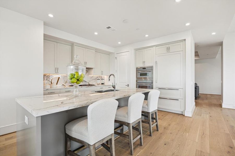 Another view of the island.  The Sub-Zero integrated refrigerator with cabinet panel fronts blends in and provide a clean look in the kitchen.