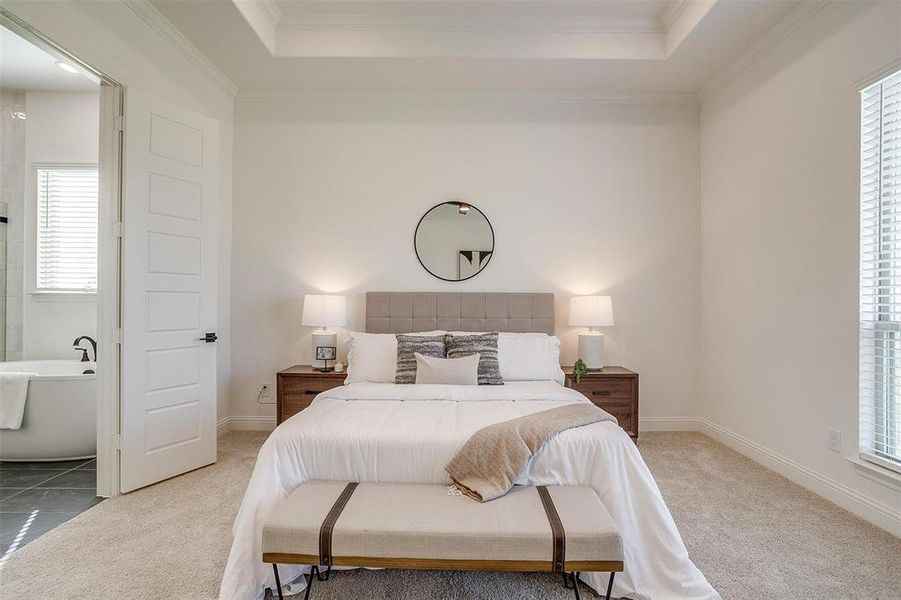 Bedroom featuring crown molding, carpet, and a raised ceiling