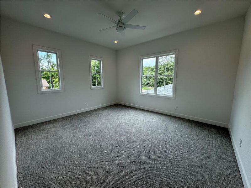 Empty room with carpet and ceiling fan