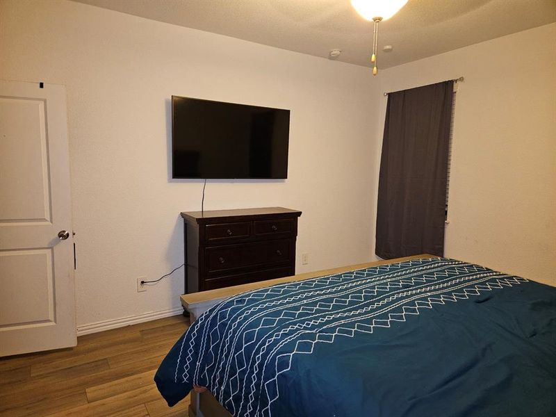 Bedroom featuring hardwood / wood-style floors and ceiling fan