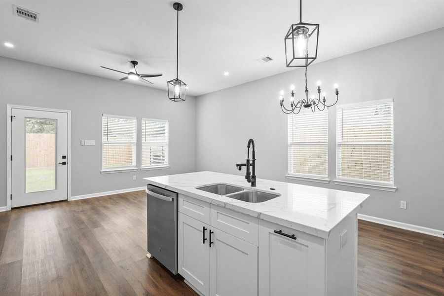 Kitchen features and island with sink.