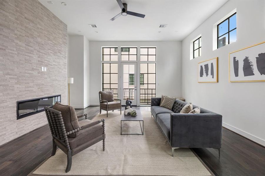 The second floor living space marries timeless elegance and contemporary flair. Hardwood floors grace the space while large windows filter in sunlight.