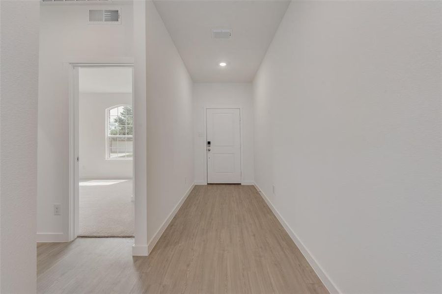 Hall featuring light hardwood / wood-style flooring