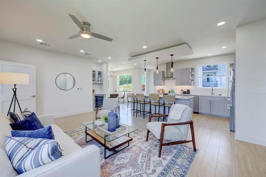 VIEW LOOKING TOWARD THE DINING ROOM. QUARTZ COUNTERTOPS IN KITCHEN IN ALL BATHROOMS AND BOSCH APPLIANCES INCLUDING REFRIGERATOR COME STANDARD IN ALL CONDOS