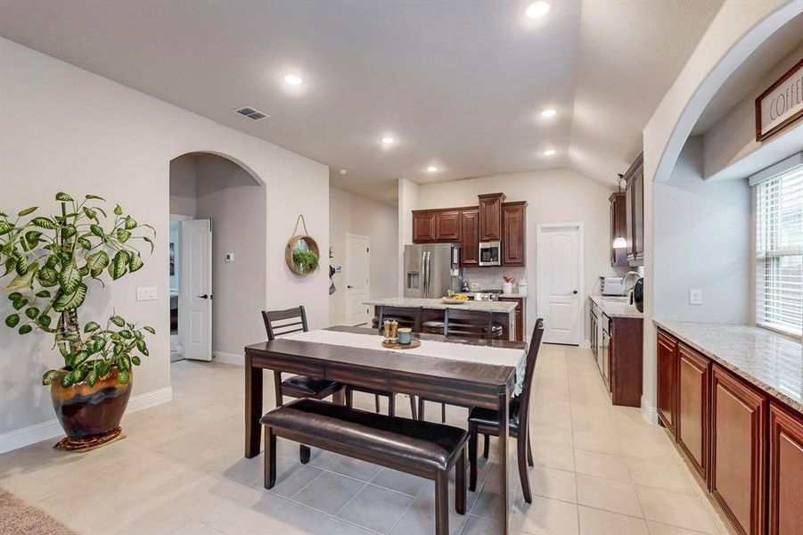 Tiled dining space with vaulted ceiling