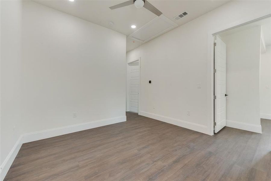 Spare room with ceiling fan and wood-type flooring