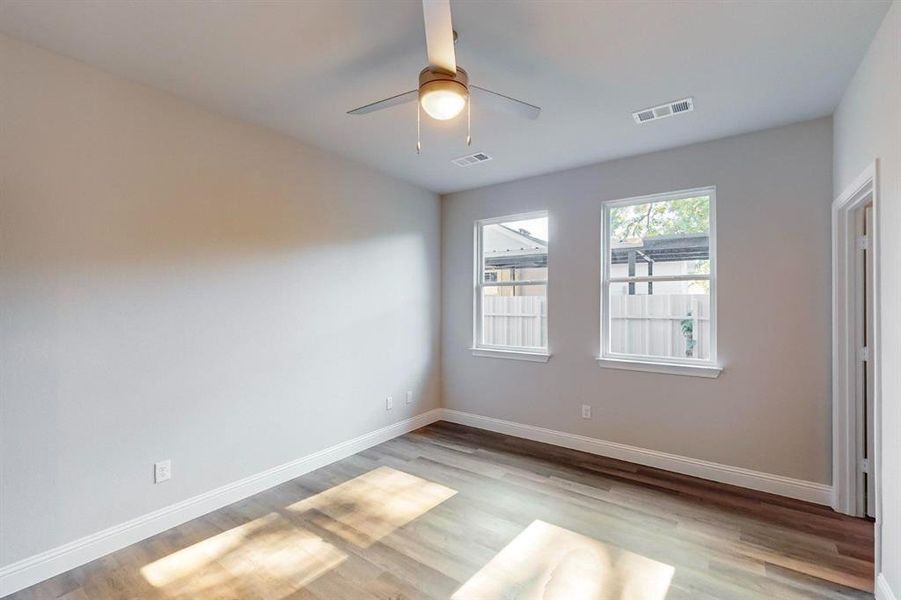 Spare room with light wood-type flooring and ceiling fan