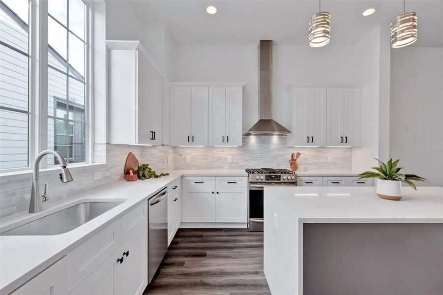 The kitchen features large windows above the sink, providing a bright and airy feel while offering an abundance of natural light.