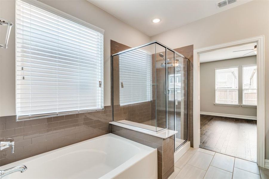 Bathroom featuring separate shower and tub and hardwood / wood-style flooring