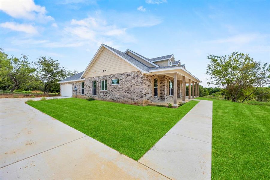 Side View of home's exterior featuring a garage and a porch