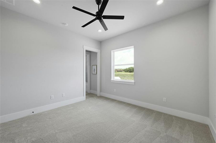 One of the four bedrooms with large window, walk in closet, recessed lighting and ceiling fan.