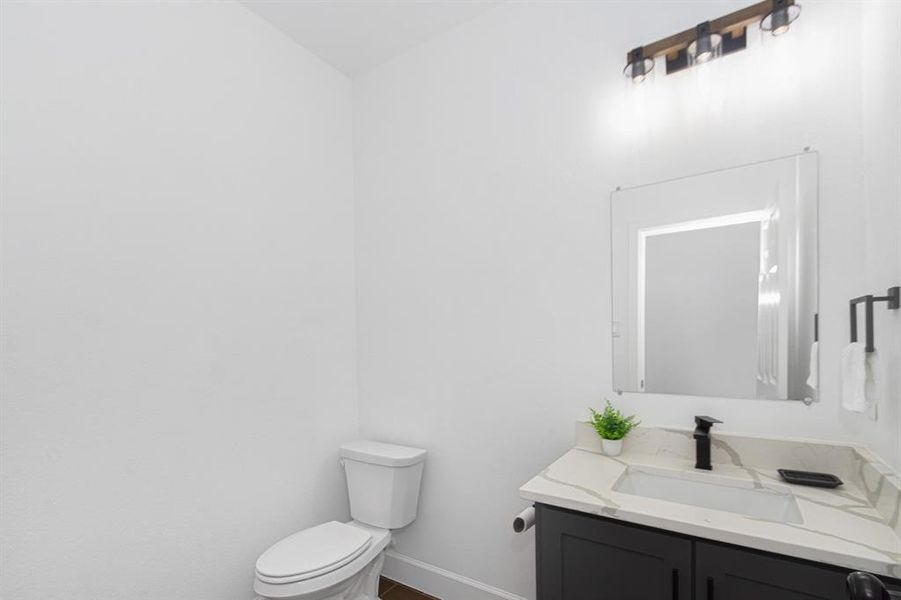 Half Bath with modern plumbing and light fixtures.