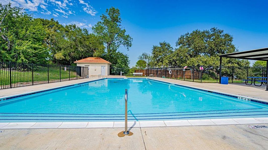 View of community swimming pool with an outbuilding