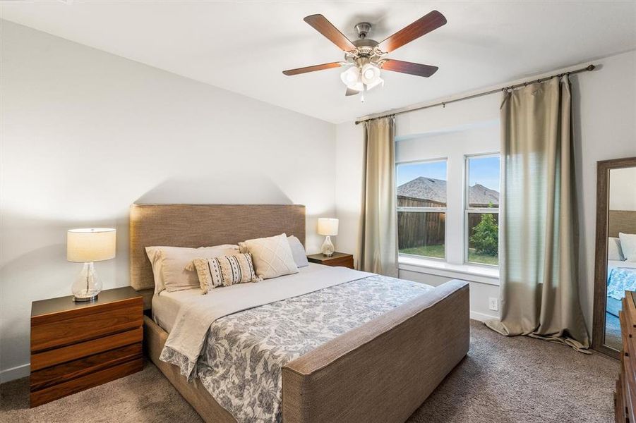 Bedroom featuring ceiling fan and light colored carpet