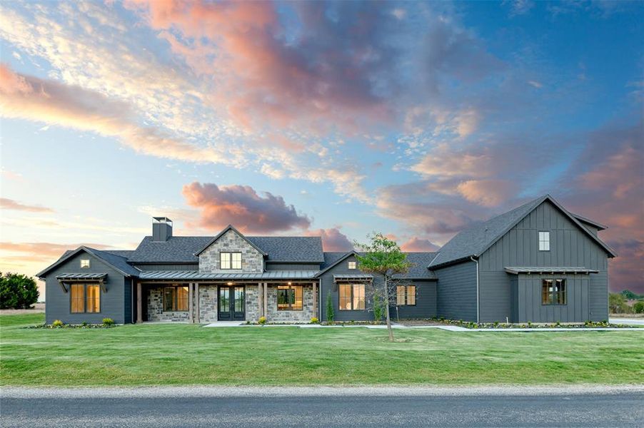 Modern farmhouse style home with a yard