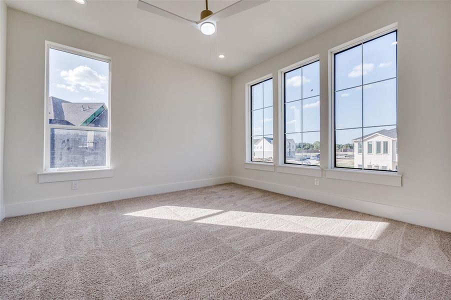 Spare room with carpet flooring and ceiling fan