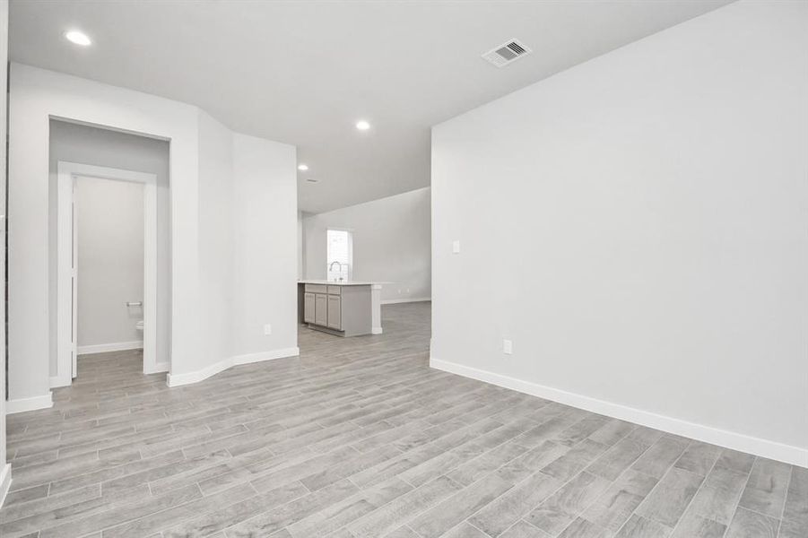 Make memories gathered around the table with your family and friends! This dining spacious room features elegant flooring, custom paint, and adjacent to family room and kitchen for open concept feel. Sample photo of completed home with similar floor plan. As-built interior colors and selections may vary.