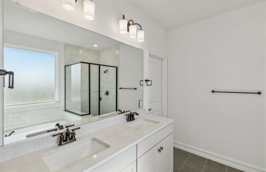 Spacious owner's bathroom with dual vanity *real home pictured