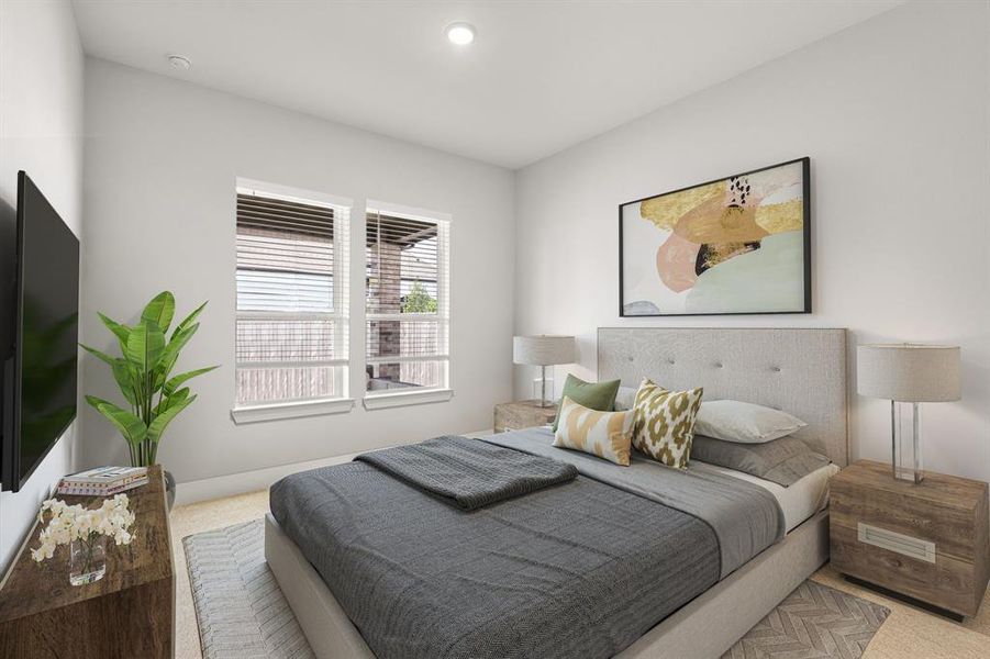 The second bedroom, located downstairs, features carpeted flooring, two windows that offer ample natural light, and elegant 6-inch baseboards, adding a touch of sophistication to the room. *Virtually Staged*