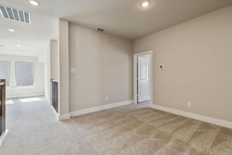 Unfurnished room with light colored carpet