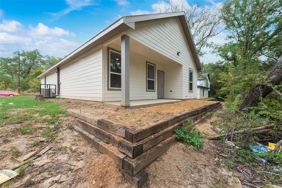 View of property exterior with cooling unit and a patio