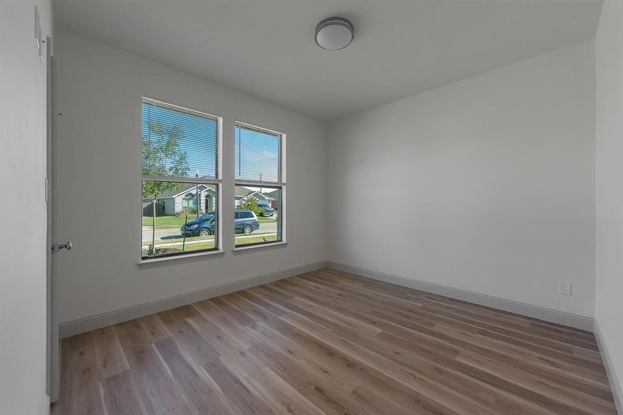 Unfurnished room with light wood-type flooring