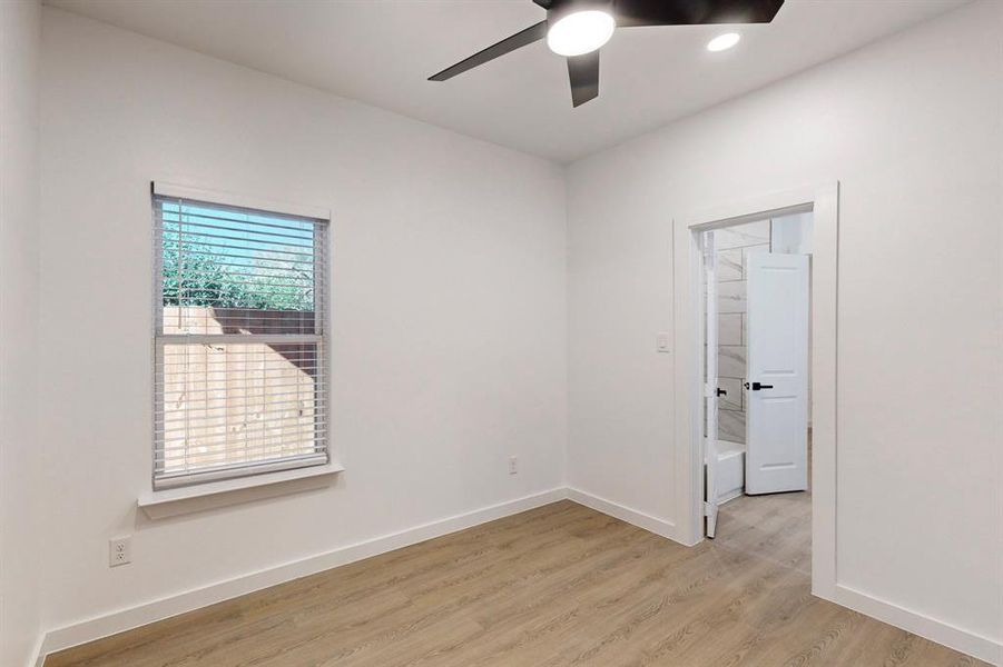 Spare room featuring light wood-type flooring and ceiling fan