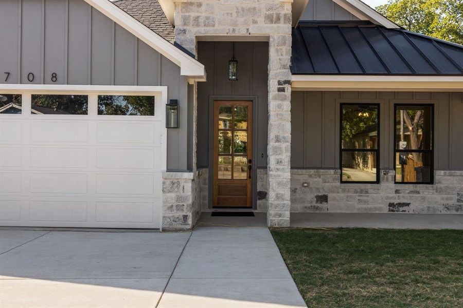 Doorway to property with a garage