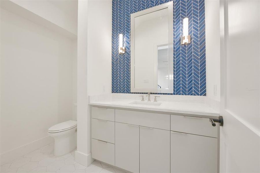 The powder room off the entry is just another example of attention to detail. for this spectacular home.