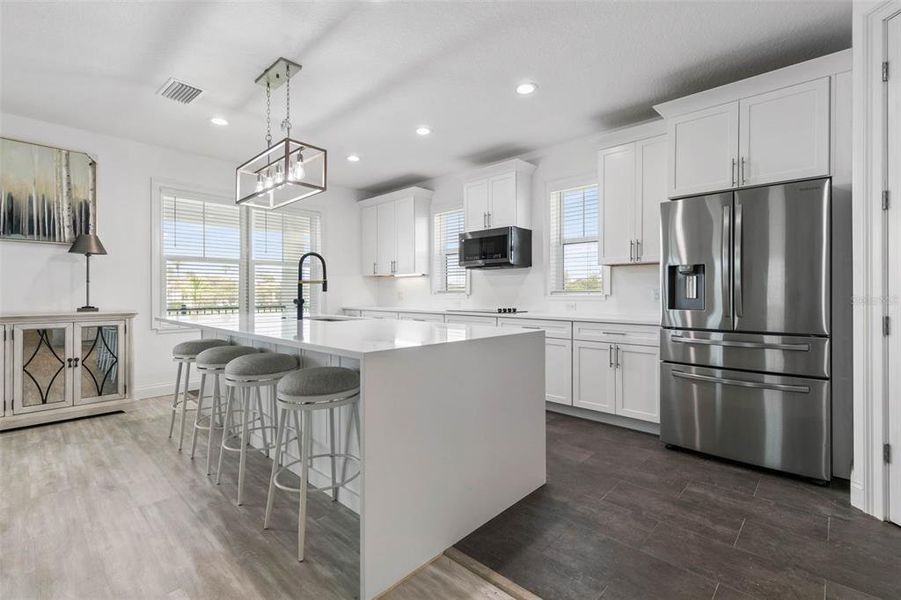 Stunning Bright Kitchen with Waterfall Countertop Island.