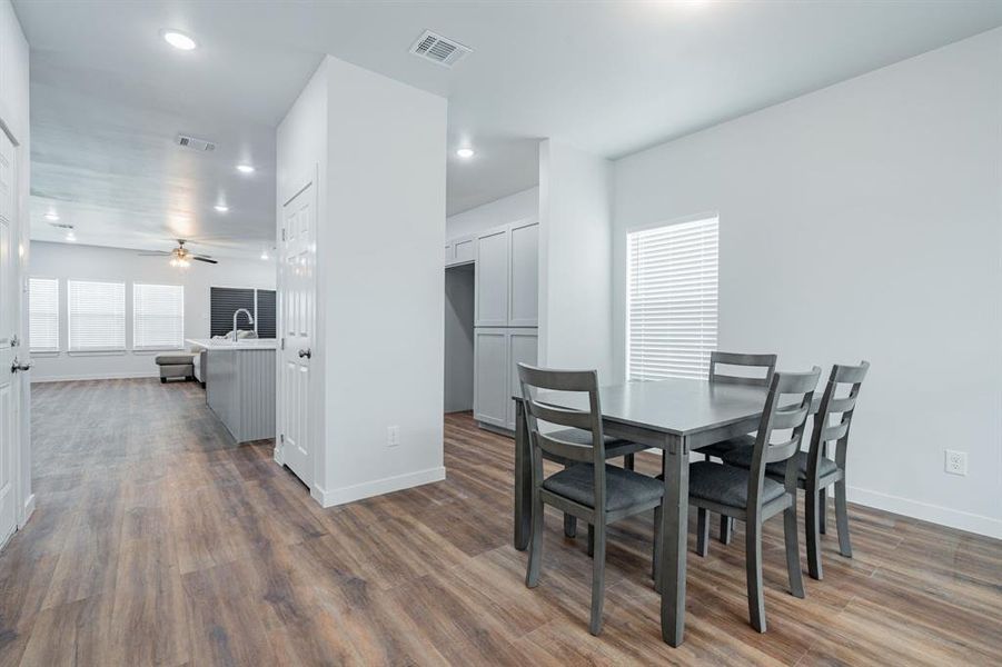 Dining room featuring ceiling fan and hardwood / wood-style flooring