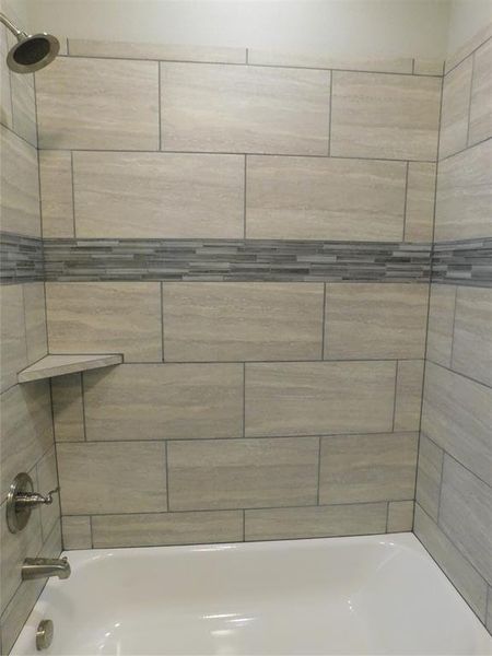 Bathroom featuring tiled shower / bath