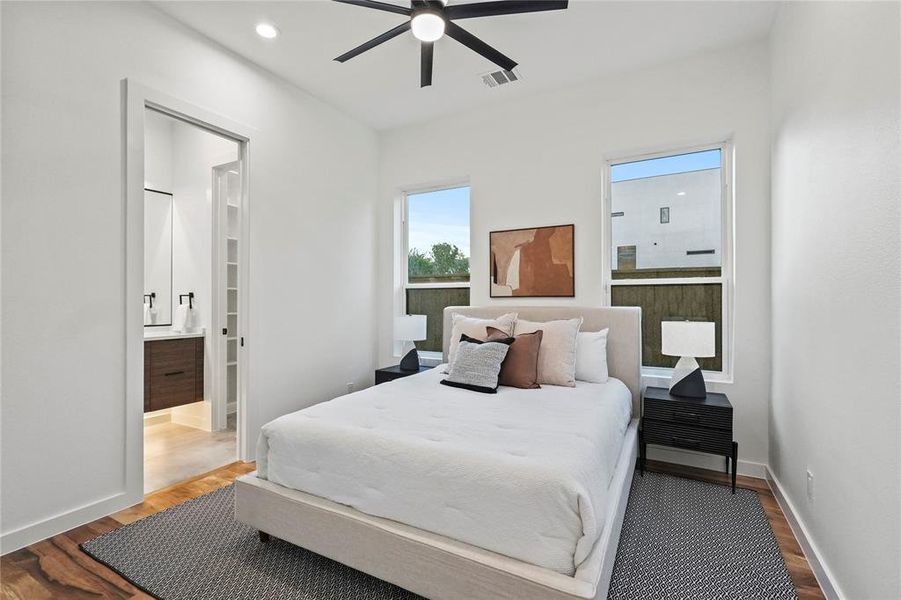 Bedroom featuring ceiling fan, hardwood / wood-style flooring, and connected bathroom