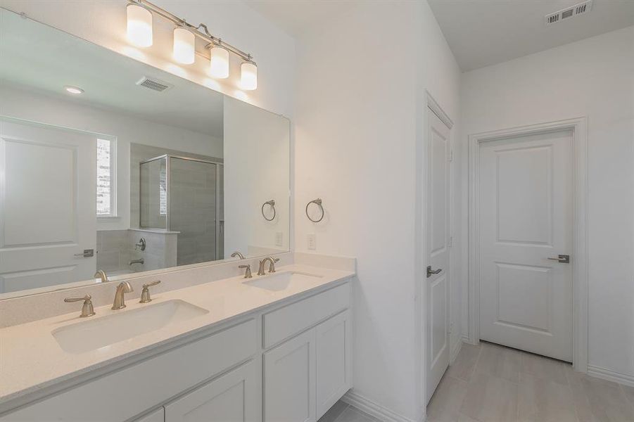 Bathroom featuring plus walk in shower and vanity