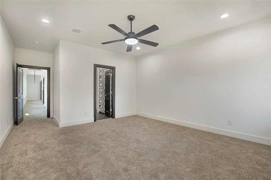 Unfurnished bedroom with ceiling fan, light carpet, and a closet