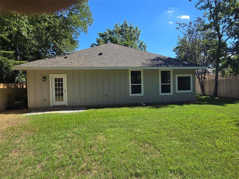 Back of house with a yard