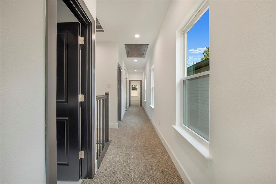 Hallway with light colored carpet