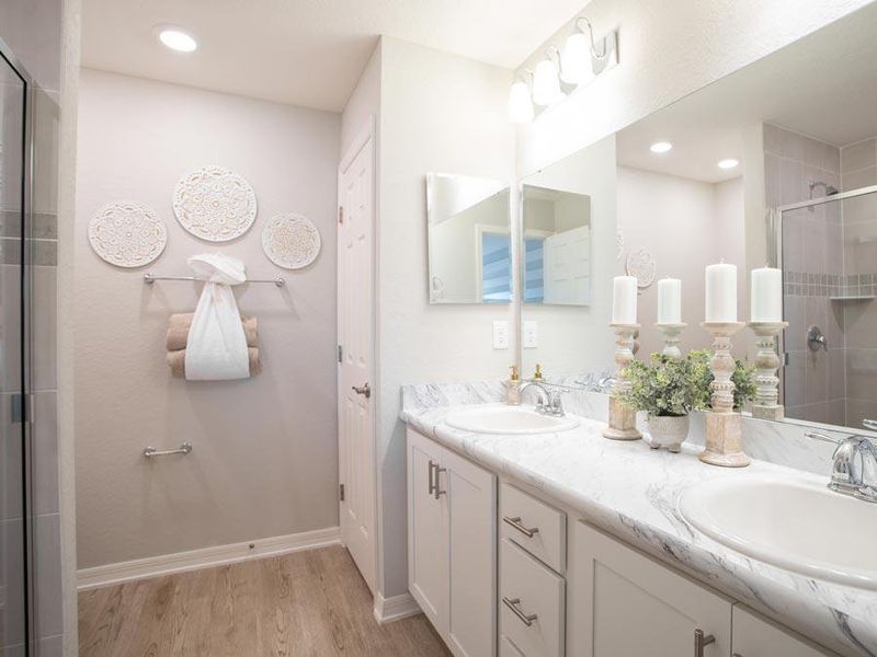 Your suite is complete with an en-suite bath (shown with optional dual vanities) - Amaryllis home plan by Highland Homes